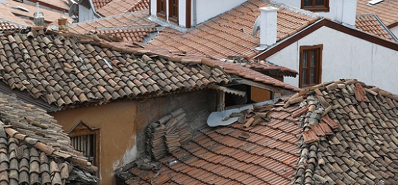 house with broken roof tiles